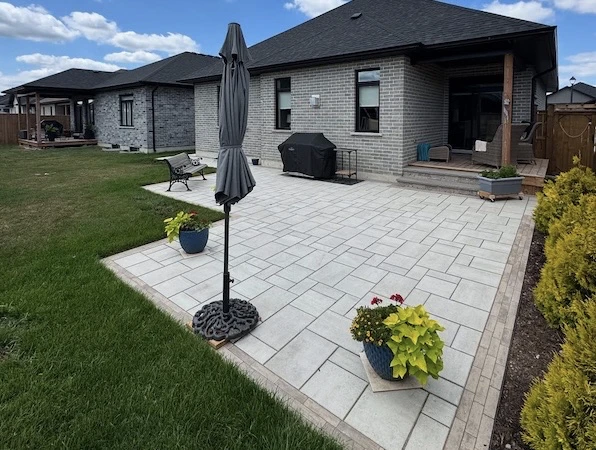 Backyard interlock patio with grass in Vaughan, Ontario