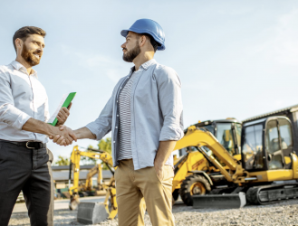 Construction contractor shaking hand of client